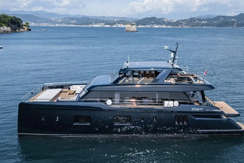 Petite Belle Yacht Photos Pics Luxurious 2025 Sunreef 100 Power yacht cruising in scenic coastal waters.