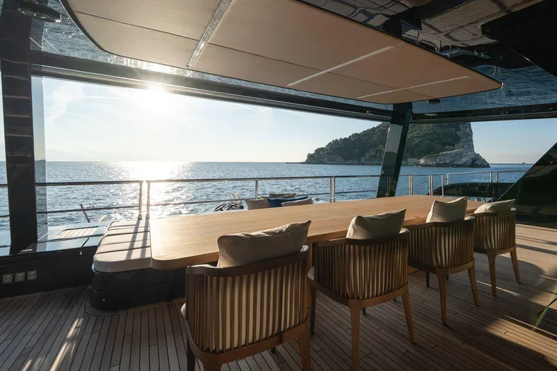Petite Belle Yacht Photos Pics Luxurious Sunreef 100 Power yacht dining area with ocean view, 2025 model.