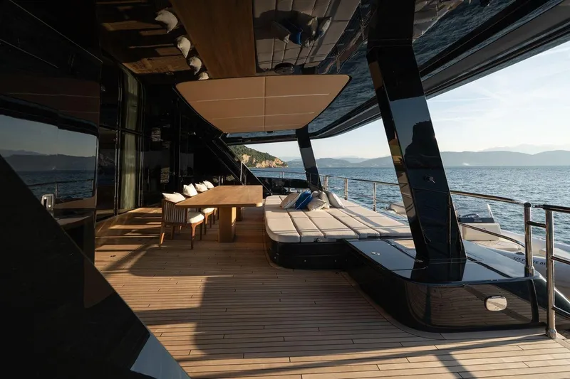 Petite Belle Yacht Photos Pics Luxurious Sunreef 100 Power yacht deck, 2025 model, featuring elegant seating and ocean views.