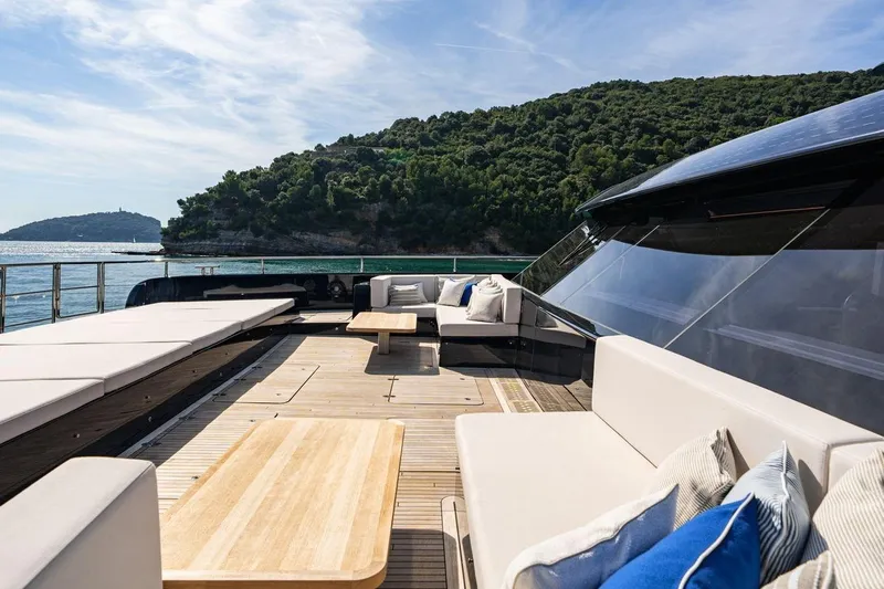 Petite Belle Yacht Photos Pics Luxurious Sunreef 100 Power yacht deck with elegant seating, scenic ocean view, 2025 model.