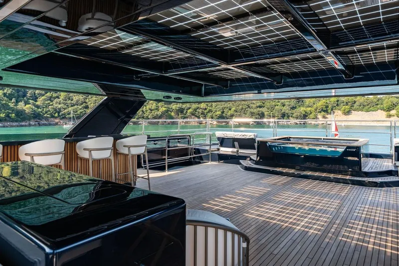 Petite Belle Yacht Photos Pics Luxurious Sunreef 100 Power yacht interior with modern seating and scenic ocean view, 2025 model.