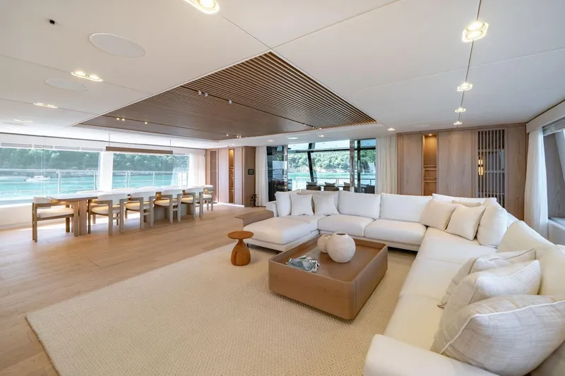 Petite Belle Yacht Photos Pics Luxurious interior of 2025 Sunreef 100 Power yacht with spacious seating and dining area.