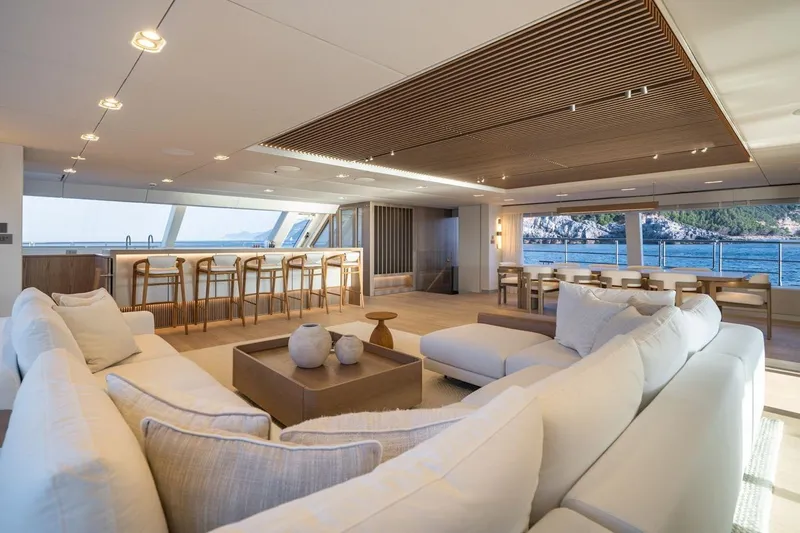 Petite Belle Yacht Photos Pics Luxurious interior of 2025 Sunreef 100 Power yacht with elegant seating and ocean view.