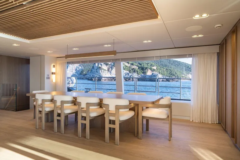 Petite Belle Yacht Photos Pics Luxurious dining area on 2025 Sunreef 100 Power yacht with ocean view.