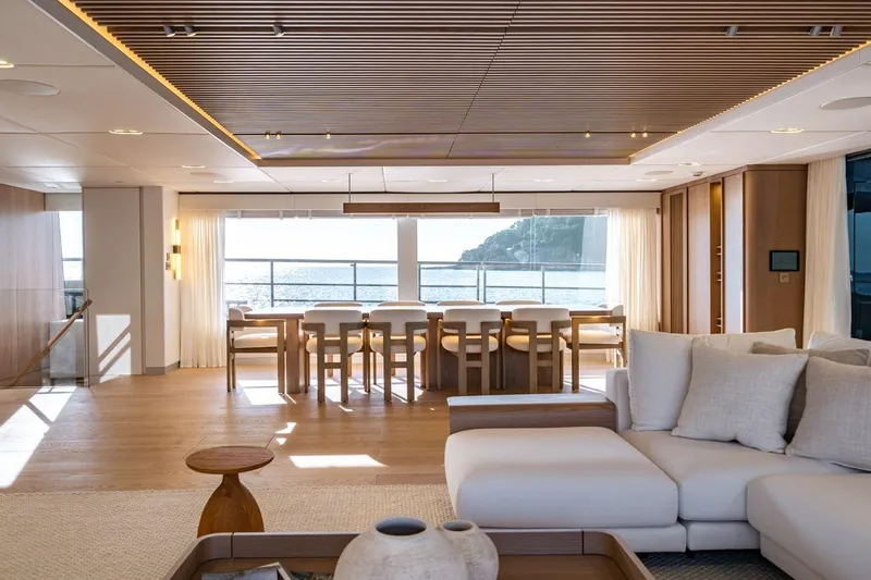 Petite Belle Yacht Photos Pics Luxurious interior of 2025 Sunreef 100 Power yacht with elegant dining area and ocean view.