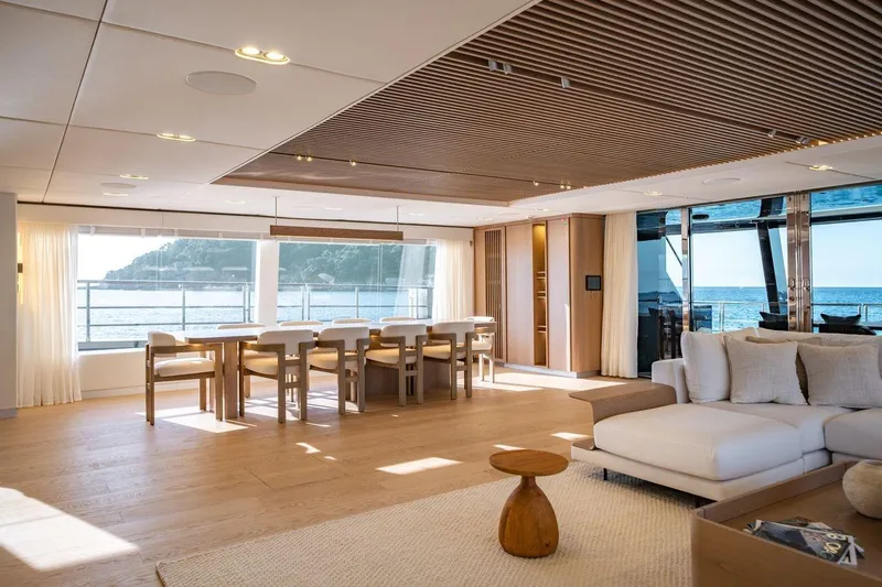 Petite Belle Yacht Photos Pics Luxurious interior of 2025 Sunreef 100 Power yacht with ocean view and elegant furnishings.