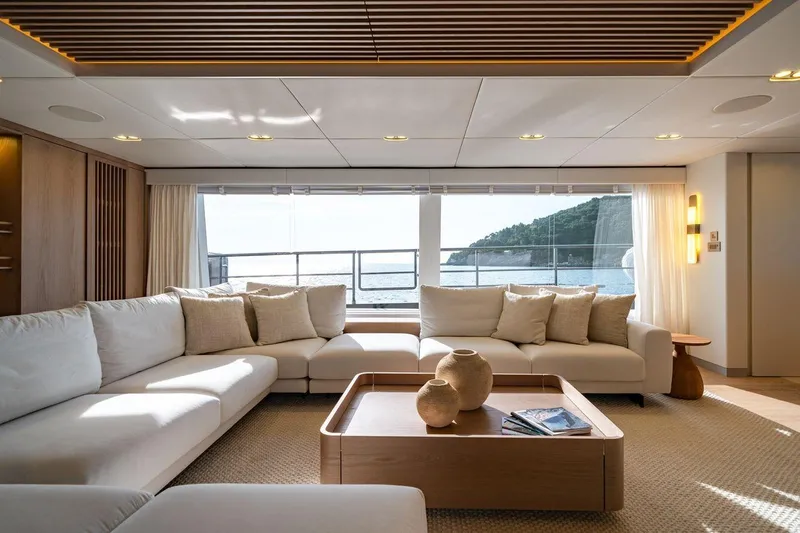 Petite Belle Yacht Photos Pics Luxurious Sunreef 100 Power yacht interior, 2025 model, featuring elegant seating and ocean view.