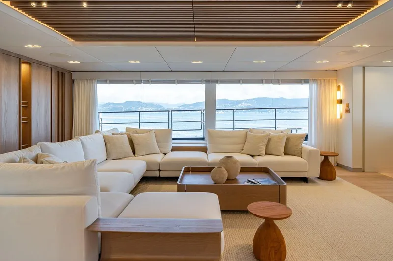 Petite Belle Yacht Photos Pics Luxurious Sunreef 100 Power yacht interior, 2025 model, featuring elegant seating and ocean view.