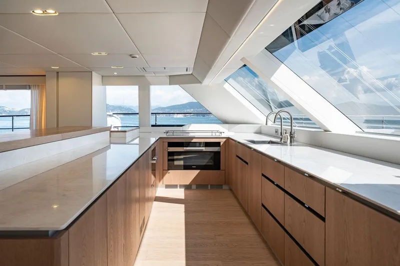 Petite Belle Yacht Photos Pics Luxurious kitchen interior of 2025 Sunreef 100 Power yacht with panoramic windows and modern design.