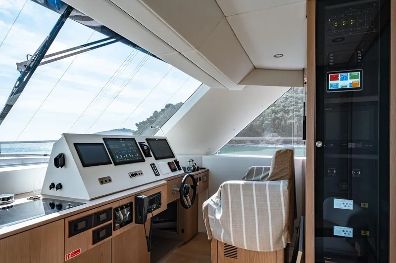 Petite Belle Yacht Photos Pics Pilothouse of 2025 Sunreef 100 Power yacht with modern navigation equipment and panoramic windows.