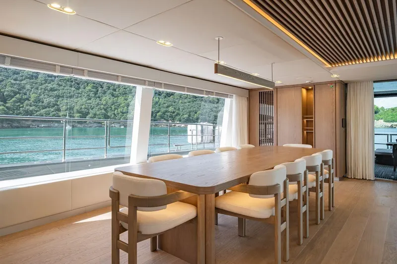 Petite Belle Yacht Photos Pics Luxurious dining area on 2025 Sunreef 100 Power yacht with scenic ocean view.
