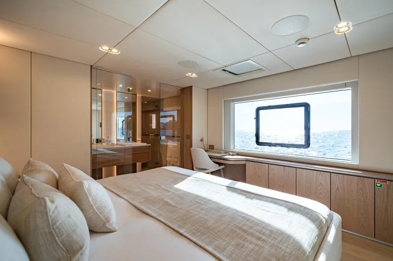 Petite Belle Yacht Photos Pics Luxurious bedroom interior of 2025 Sunreef 100 Power yacht with ocean view.