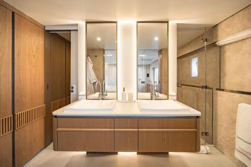 Petite Belle Yacht Photos Pics Luxurious bathroom interior on 2025 Sunreef 100 Power yacht, featuring dual sinks and modern design.