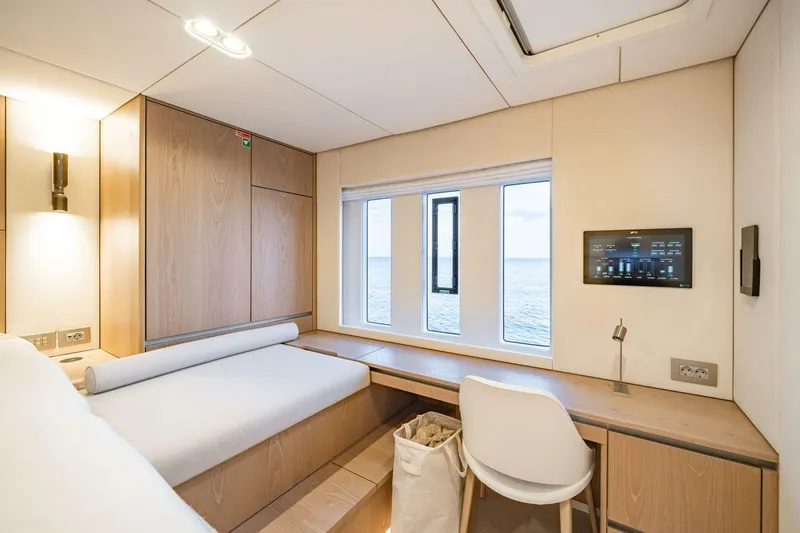 Petite Belle Yacht Photos Pics Luxurious cabin interior of 2025 Sunreef 100 Power yacht with ocean view.
