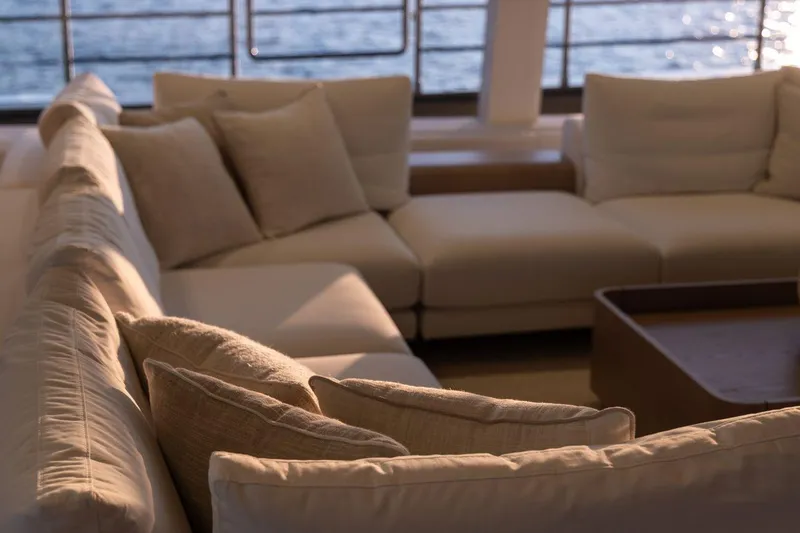 Petite Belle Yacht Photos Pics Luxurious Sunreef 100 Power yacht interior with elegant beige seating, 2025 model.