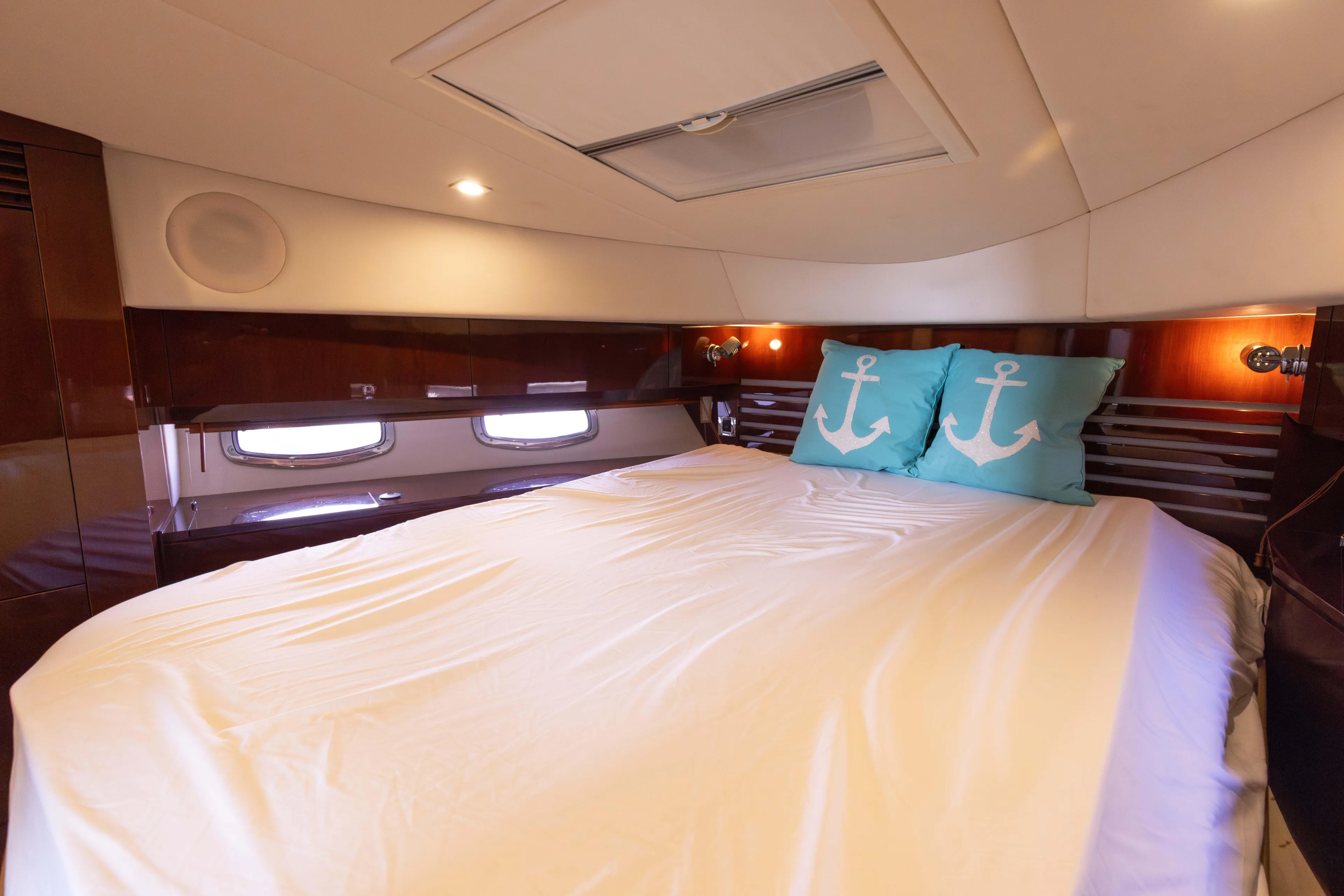 Ka-bar Yacht Photos Pics Luxurious bedroom in 2012 Sea Ray 450 Sedan yacht with anchor-themed pillows.