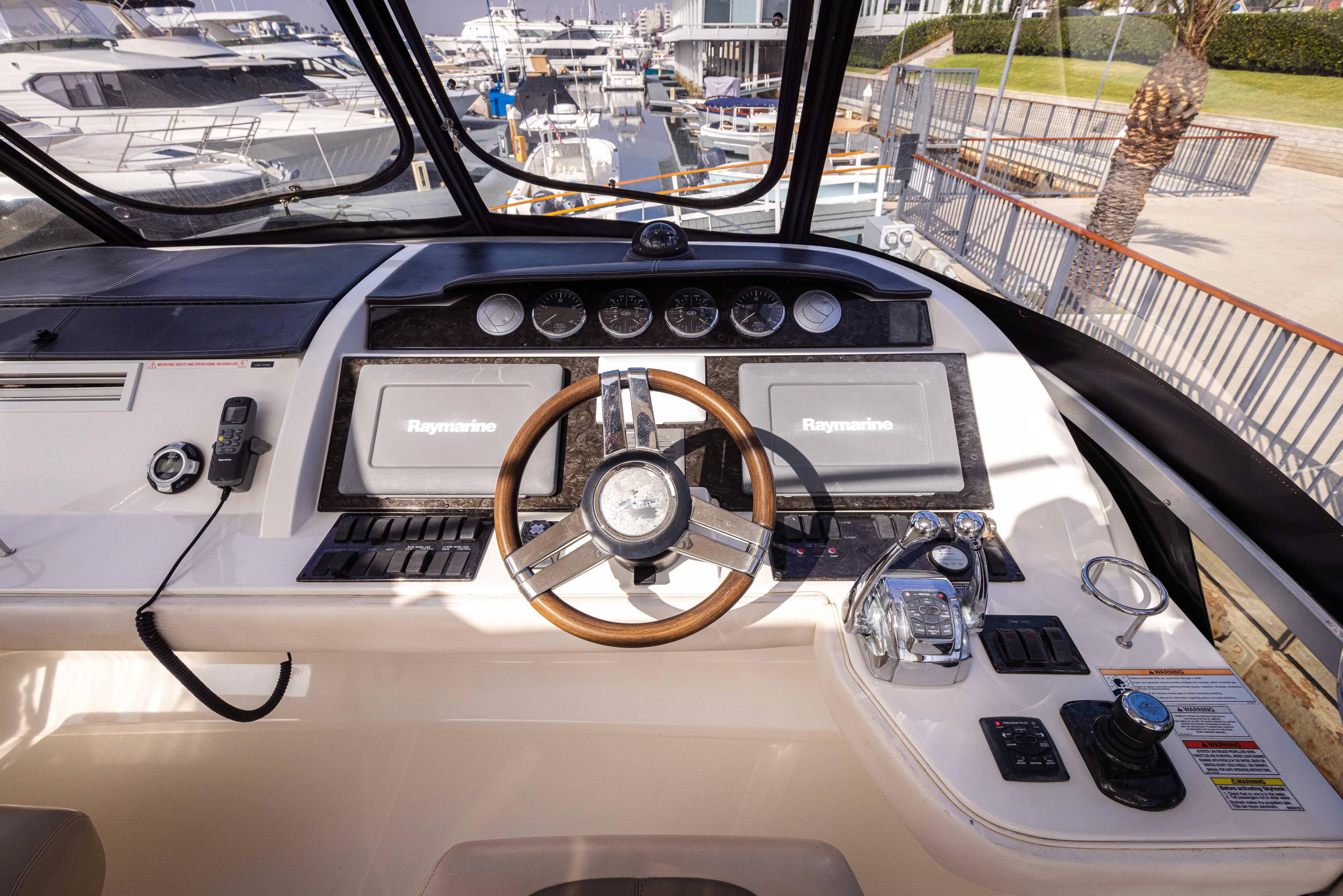 Ka-bar Yacht Photos Pics Cockpit of 2012 Sea Ray 450 Sedan with modern navigation equipment and steering wheel.