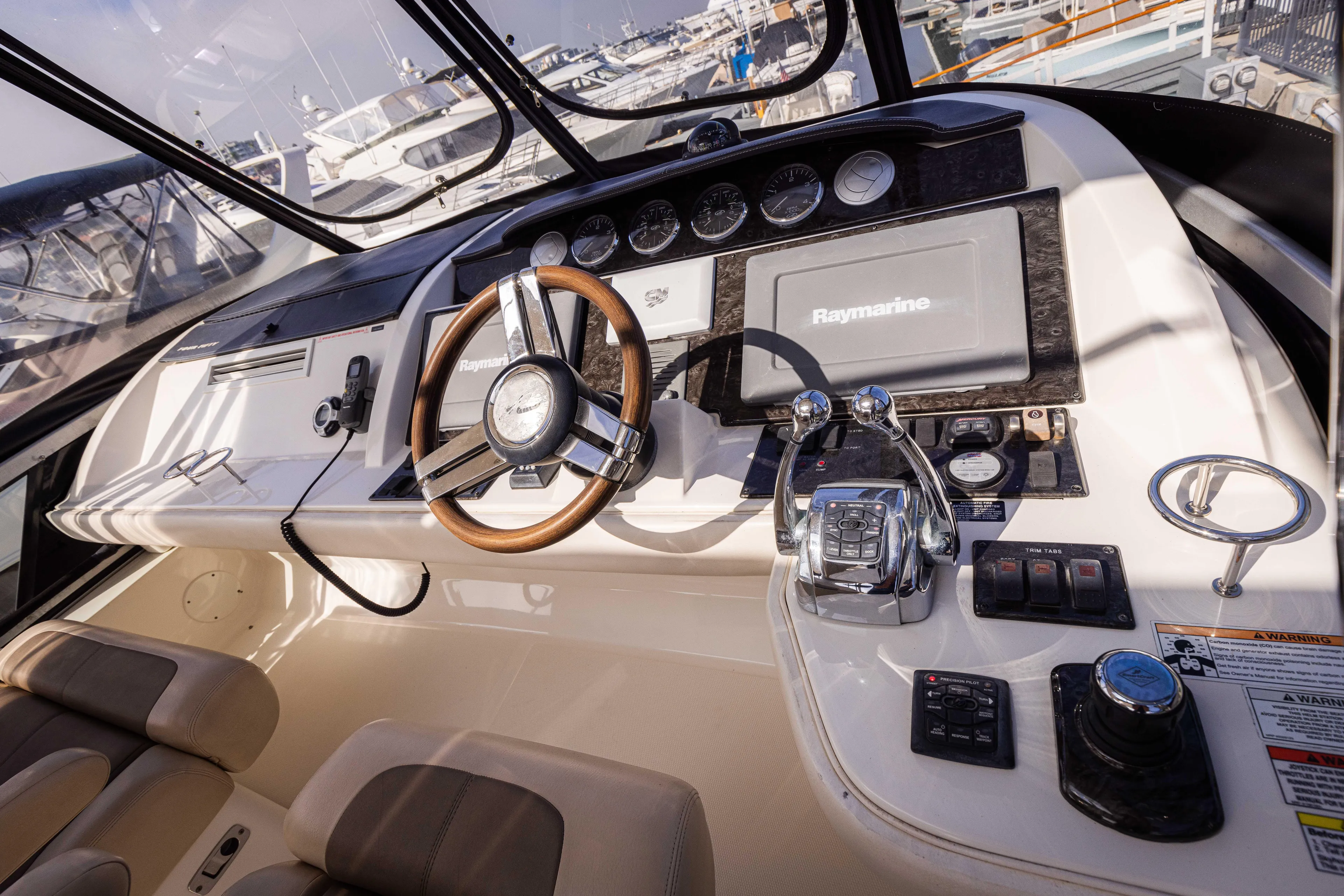 Ka-bar Yacht Photos Pics Interior cockpit of 2012 Sea Ray 450 Sedan with steering wheel and navigation controls.