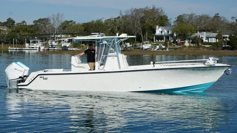  Yacht Photos Pics 2017 SeaVee 320B boat on calm water, with a person at the helm.