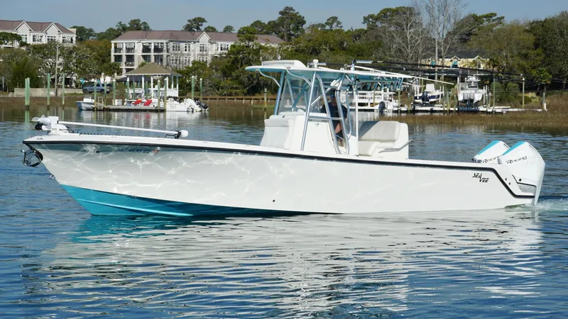  Yacht Photos Pics 2017 SeaVee 320B boat on calm water, with a scenic waterfront background.