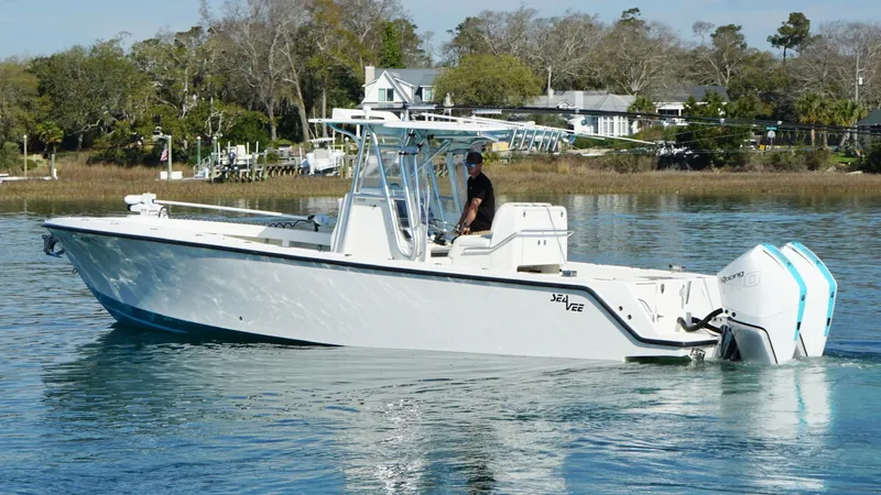  Yacht Photos Pics 2017 SeaVee 320B boat cruising on calm water near a scenic shoreline.