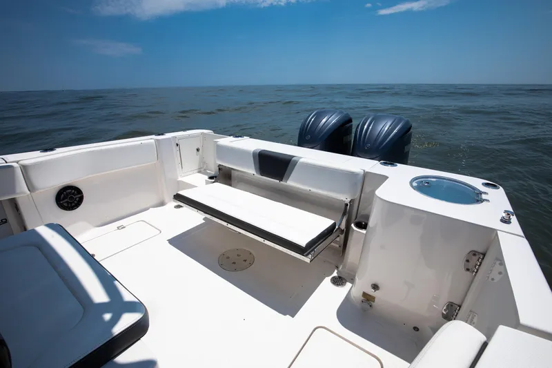  Yacht Photos Pics 2023 Robalo R270 Center Console boat interior with seating and twin engines on open water.