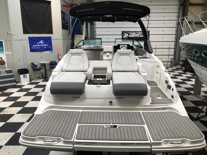  Yacht Photos Pics 2025 Sea Ray SDX 290 boat in showroom, featuring sleek seating and modern design.