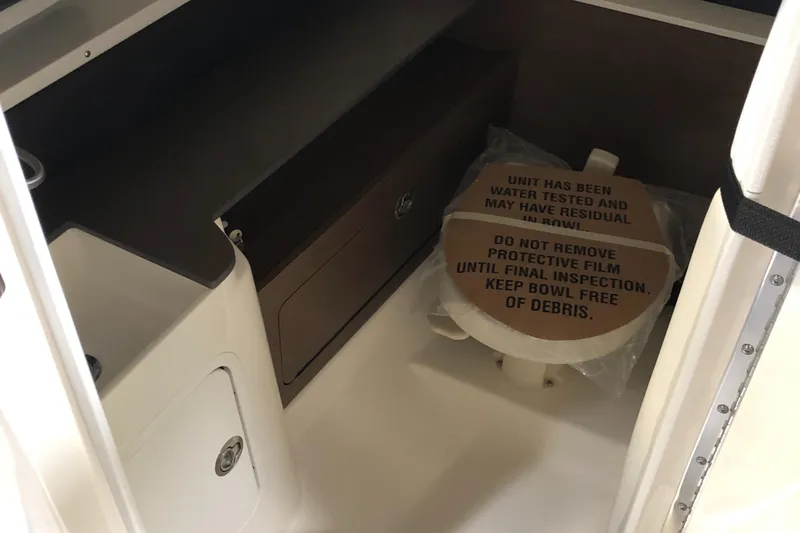  Yacht Photos Pics 2025 Sea Ray SDX 290 interior with protective film on toilet, showcasing sleek design.