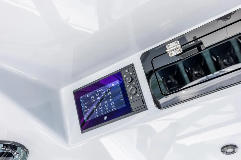  Yacht Photos Pics 2026 Yellowfin 39 Offshore boat dashboard with digital display and storage compartment.