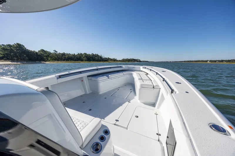  Yacht Photos Pics 2026 Yellowfin 39 Offshore boat on calm water, clear sky, and scenic shoreline.