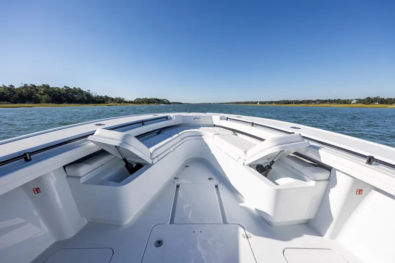  Yacht Photos Pics 2026 Yellowfin 39 Offshore boat on calm water, featuring spacious seating and clear blue skies.
