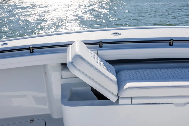  Yacht Photos Pics 2026 Yellowfin 39 Offshore boat with cushioned seating and storage, on sparkling water.