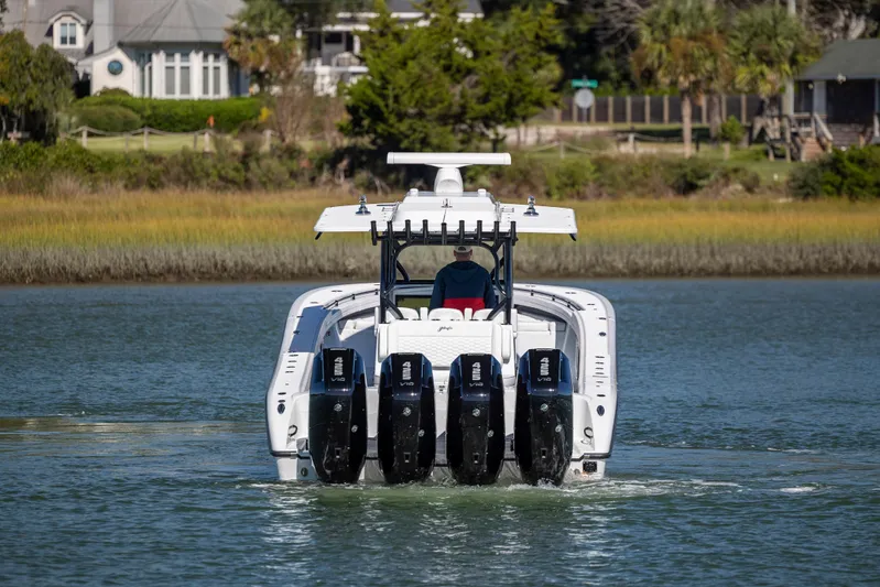  Yacht Photos Pics 2026 Yellowfin 39 Offshore boat with four engines on a calm waterway.