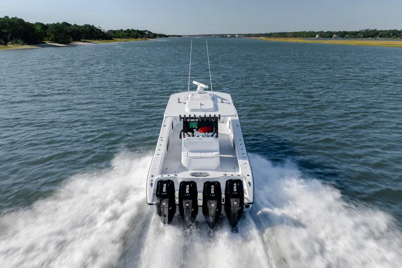  Yacht Photos Pics 2026 Yellowfin 39 Offshore boat cruising on open water, rear view.