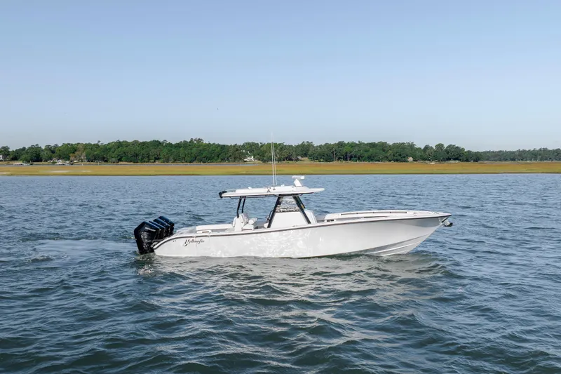  Yacht Photos Pics 2026 Yellowfin 39 Offshore boat cruising on a calm lake.