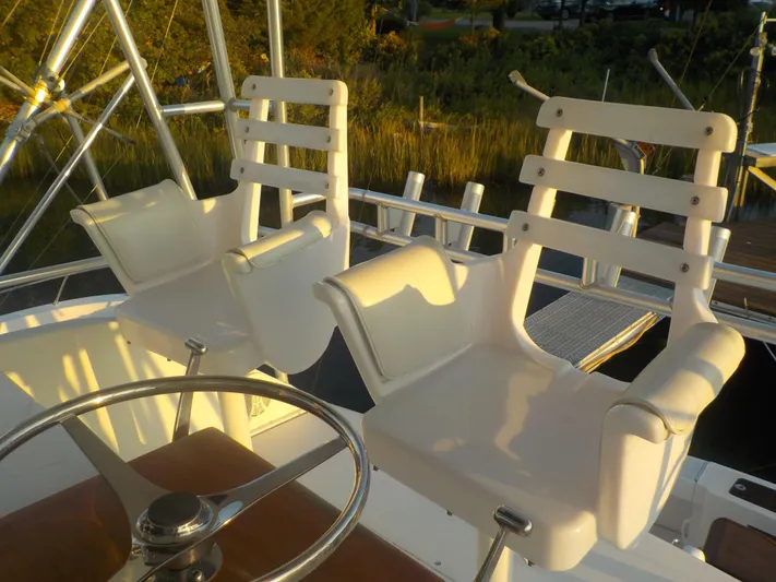 Tiramisu Yacht Photos Pics White captain chairs on 1996 Viking 47 Convertible yacht deck.