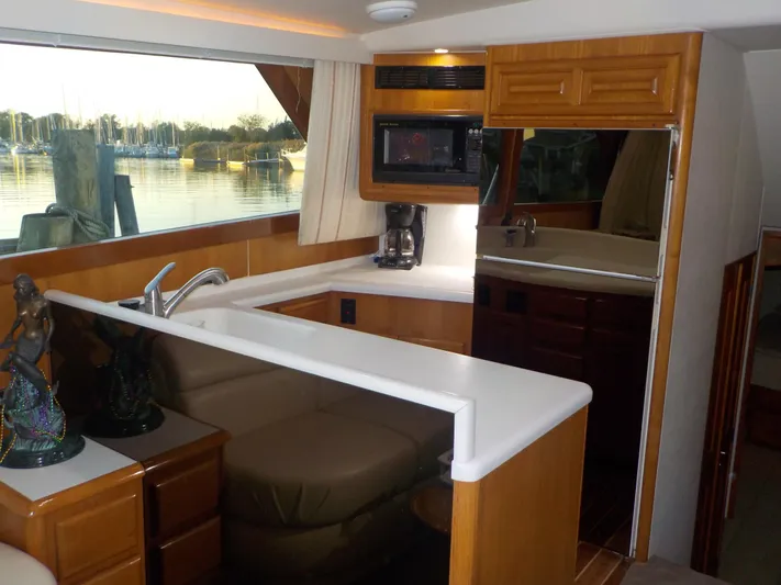 Tiramisu Yacht Photos Pics Interior of 1996 Viking 47 Convertible yacht with modern kitchen and scenic window view.