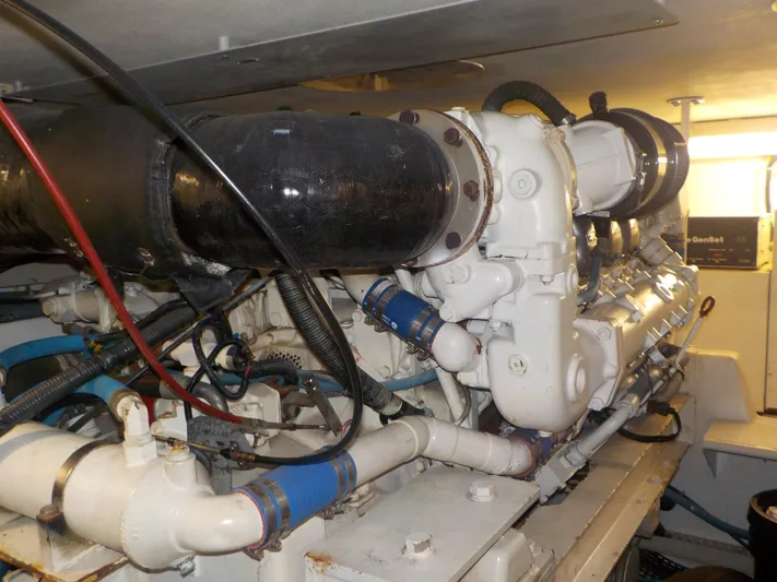 Tiramisu Yacht Photos Pics Engine room of 1996 Viking 47 Convertible yacht, showcasing complex machinery and piping.