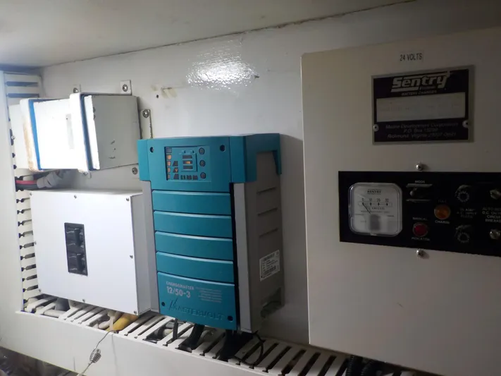 Tiramisu Yacht Photos Pics Electrical panel inside 1996 Viking 47 Convertible boat, featuring various control units.