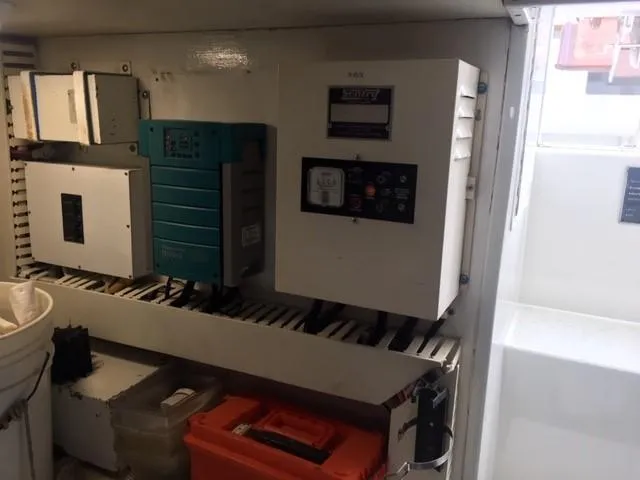 Tiramisu Yacht Photos Pics Electrical panel inside 1996 Viking 47 Convertible boat, featuring various control units and equipment.