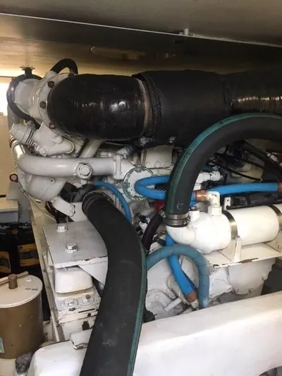 Tiramisu Yacht Photos Pics Engine room of 1996 Viking 47 Convertible yacht with visible hoses and components.