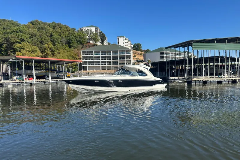  Yacht Photos Pics 2007 Formula 400 Super Sport boat docked at a marina with buildings and trees in the background.