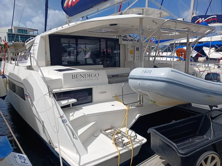 Bendigo Yacht Photos Pics 2021 Leopard 40 catamaran docked with inflatable boat attached, sunny marina setting.