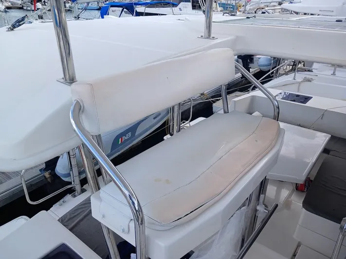 Bendigo Yacht Photos Pics Captain's seat on a 2021 Leopard 40 catamaran, featuring white upholstery and stainless steel frame.