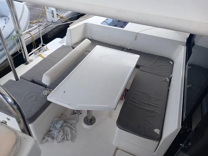 Bendigo Yacht Photos Pics Outdoor seating area on a 2021 Leopard 40 catamaran with cushioned benches and table.