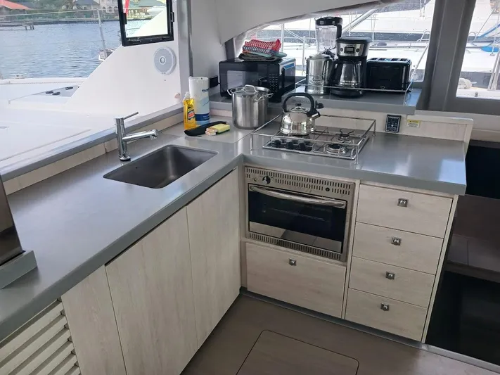 Bendigo Yacht Photos Pics Modern kitchen in a 2021 Leopard 40 catamaran with appliances and sleek countertops.