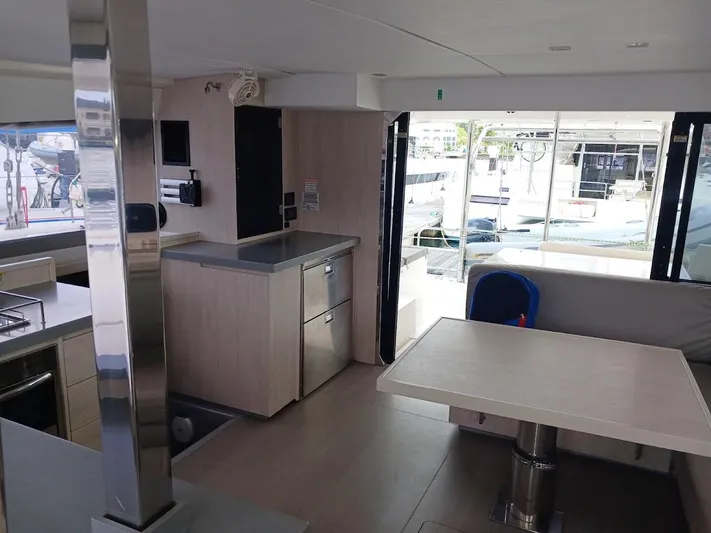 Bendigo Yacht Photos Pics Modern interior of a 2021 Leopard 40 catamaran with sleek kitchen and dining area.