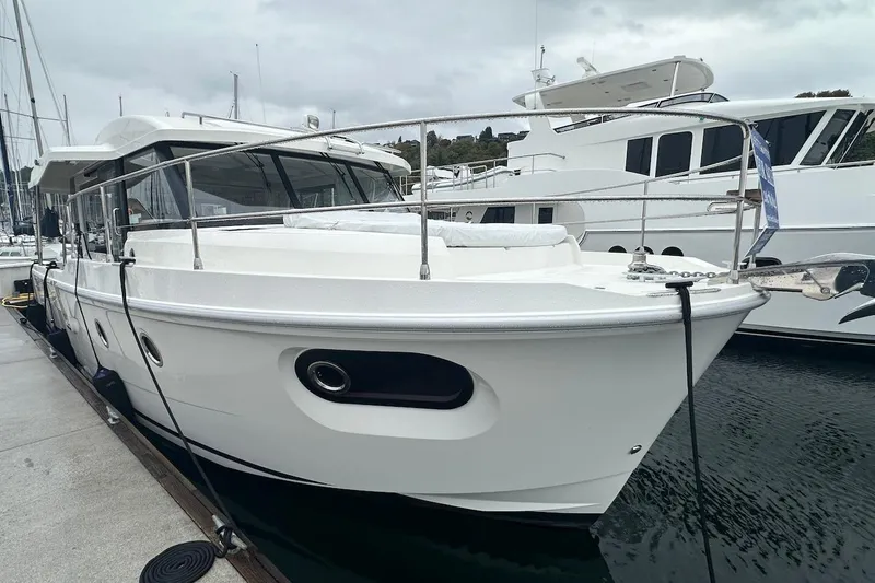 Fret Knot Yacht Photos Pics 2024 Beneteau Swift Trawler 41 Sedan docked at marina, side view.
