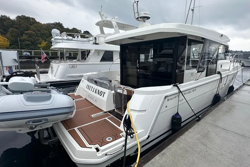Fret Knot Yacht Photos Pics 2024 Beneteau Swift Trawler 41 Sedan docked at marina, rear view.