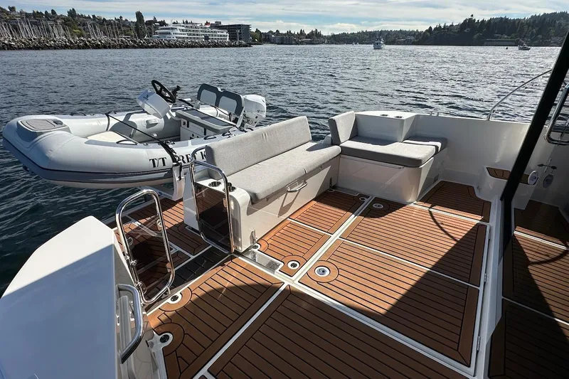 Fret Knot Yacht Photos Pics 2024 Beneteau Swift Trawler 41 Sedan deck with seating and inflatable boat.